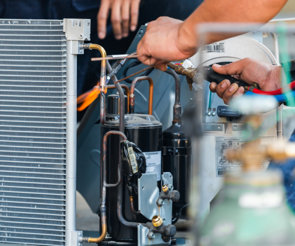 Technicians fixing Air conditioning unit