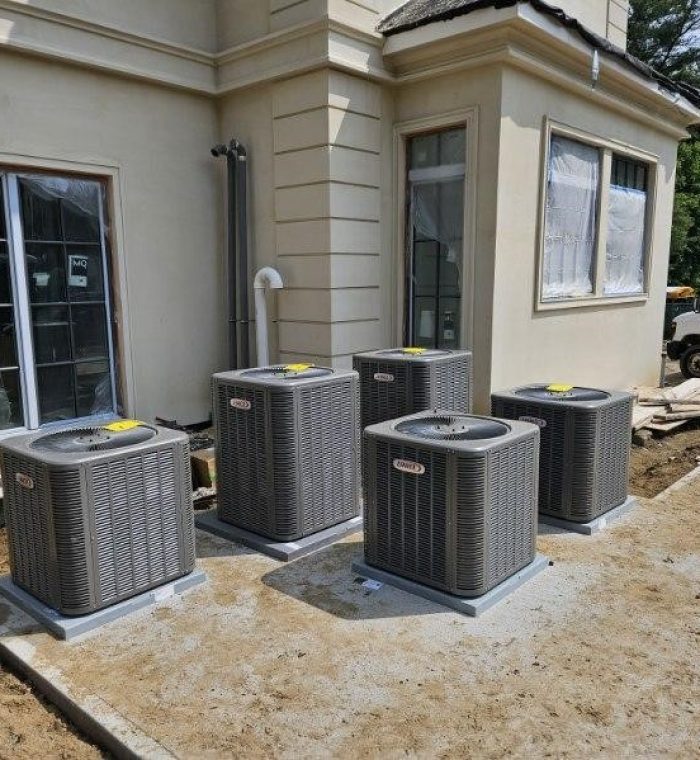 Multiple air conditioning units in front of newly renovated house